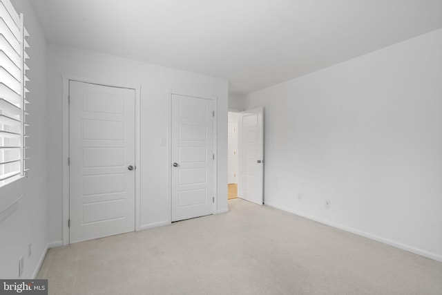 unfurnished bedroom with baseboards and carpet floors