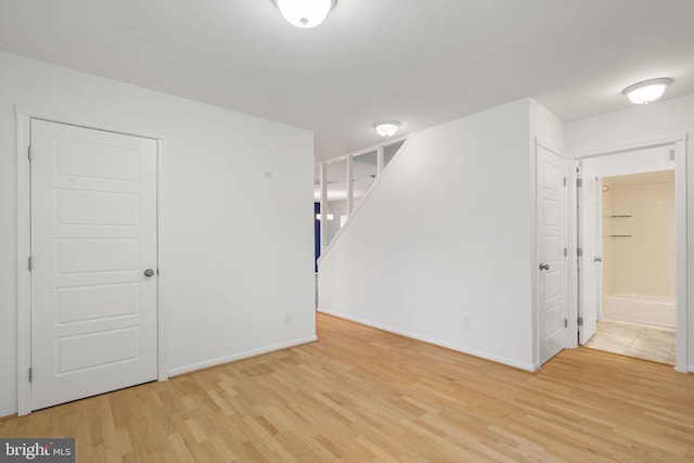 empty room featuring baseboards and wood finished floors