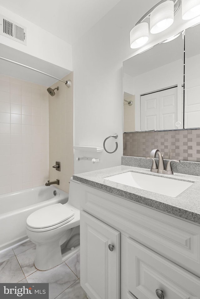 full bath featuring vanity, washtub / shower combination, visible vents, toilet, and backsplash