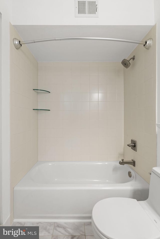 bathroom featuring visible vents, toilet, and bathtub / shower combination