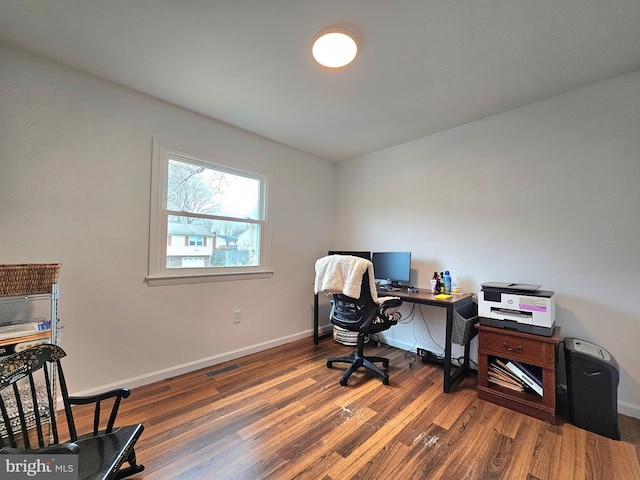 home office with visible vents, baseboards, and wood finished floors