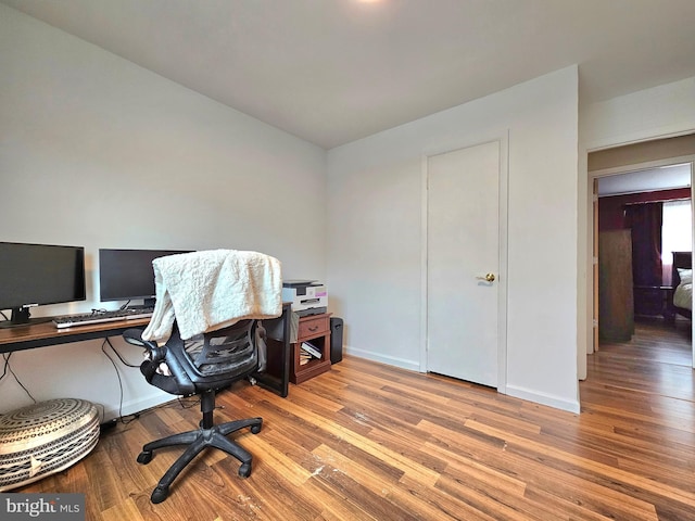 office area with wood finished floors and baseboards