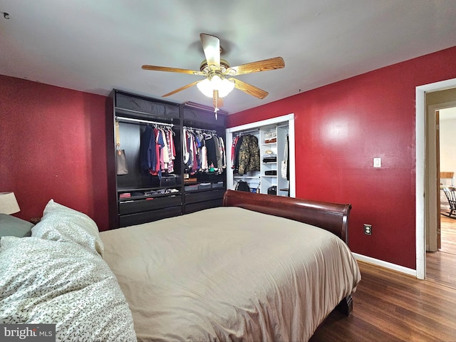 bedroom with ceiling fan, baseboards, and wood finished floors