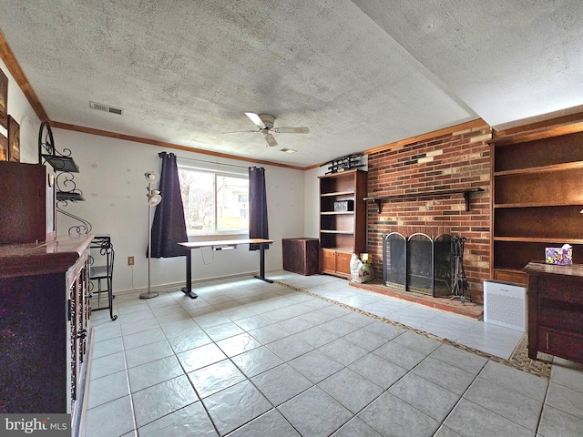 unfurnished living room with a fireplace, built in shelves, a ceiling fan, and a textured ceiling