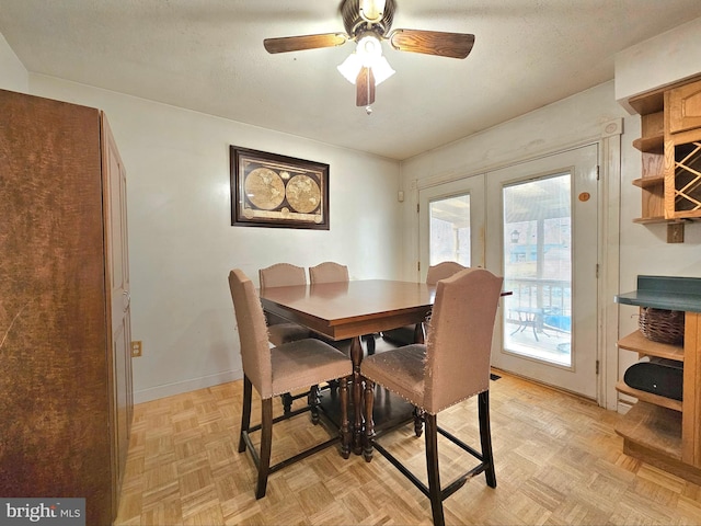 dining area with ceiling fan, french doors, and baseboards