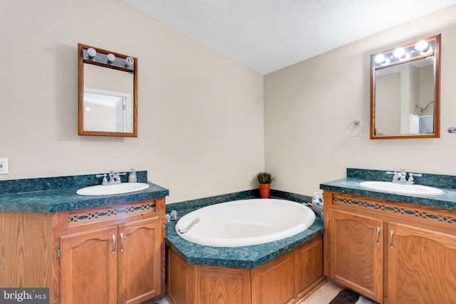 full bathroom with a bath, a sink, and two vanities