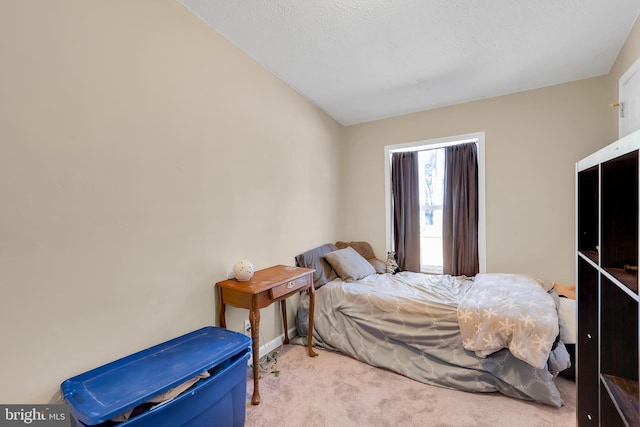 carpeted bedroom featuring a textured ceiling