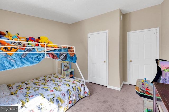 bedroom featuring baseboards and carpet flooring