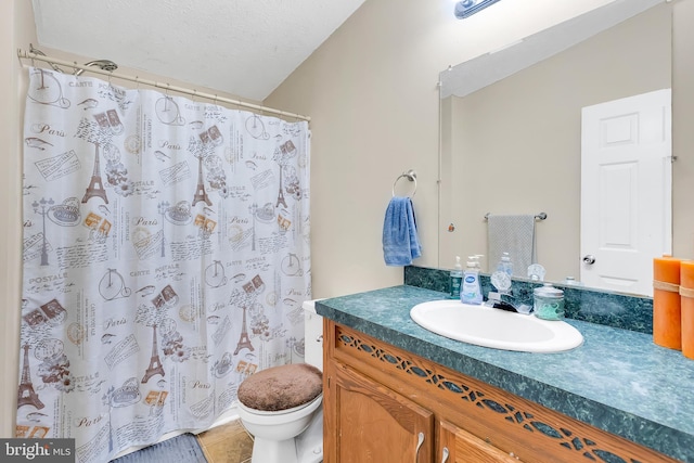 full bathroom featuring vanity, toilet, a textured ceiling, tile patterned floors, and curtained shower