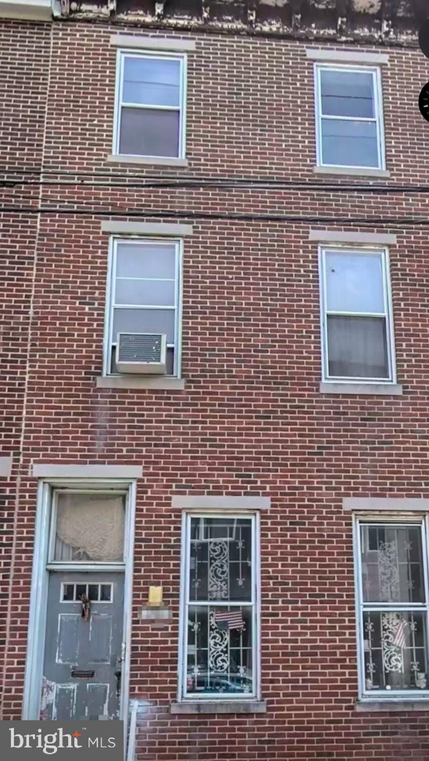 view of side of home with brick siding