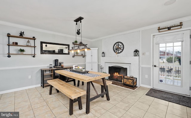 dining area featuring crown molding, light tile patterned flooring, and a fireplace