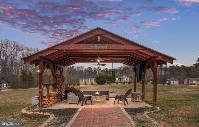 view of home's community featuring a gazebo, a patio, a fire pit, and a lawn