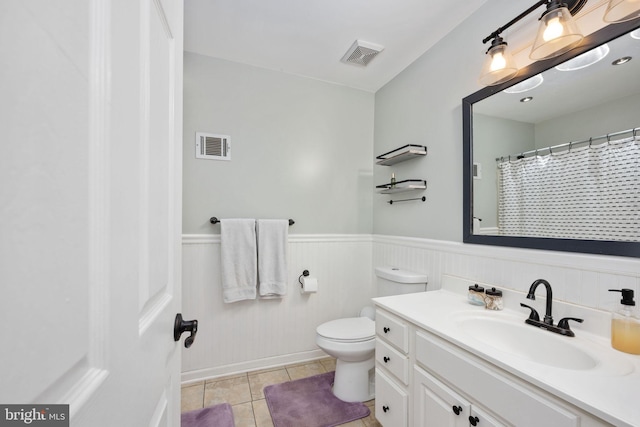 full bath with tile patterned floors, visible vents, a wainscoted wall, and vanity