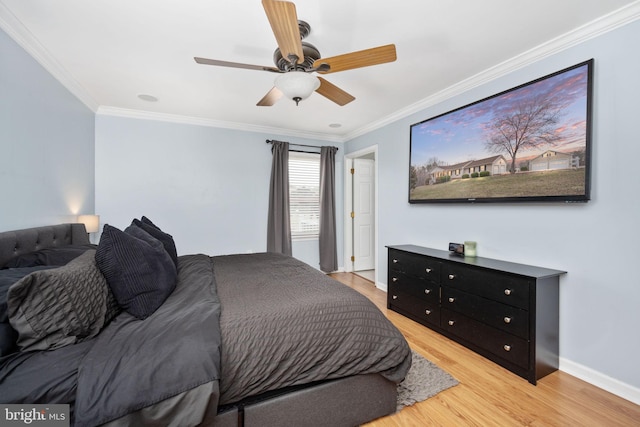 bedroom featuring light wood-type flooring, baseboards, ceiling fan, and crown molding