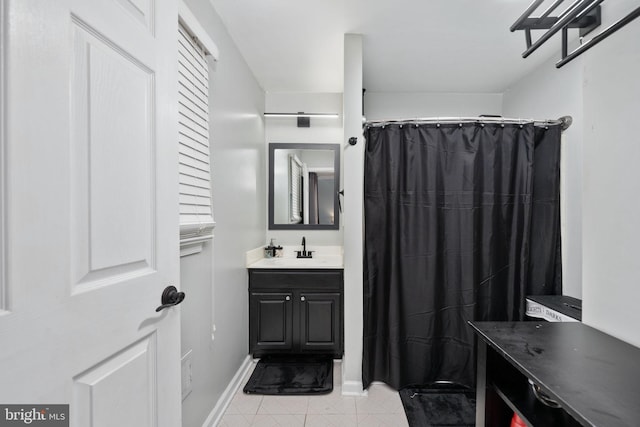 full bath with vanity, tile patterned floors, and baseboards