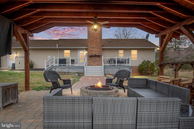 view of patio featuring an outdoor living space with a fire pit and a deck