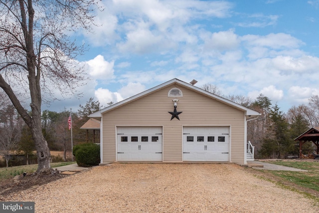 detached garage featuring driveway