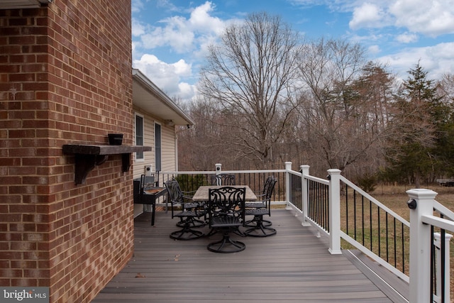 wooden terrace featuring outdoor dining space