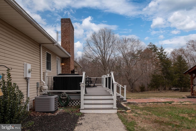 view of yard with central air condition unit and a wooden deck