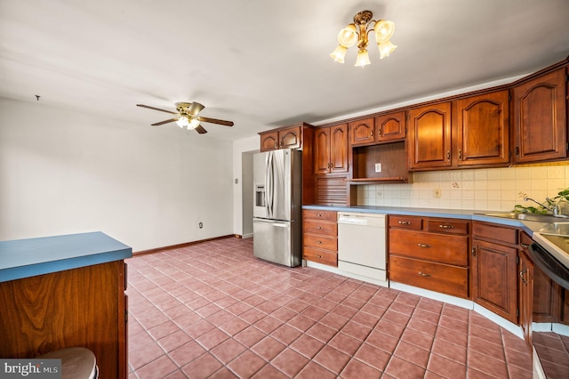 kitchen with stainless steel fridge with ice dispenser, decorative backsplash, white dishwasher, a ceiling fan, and a sink