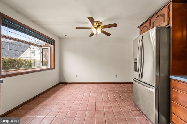 kitchen featuring light tile patterned floors, stainless steel fridge with ice dispenser, baseboards, and ceiling fan