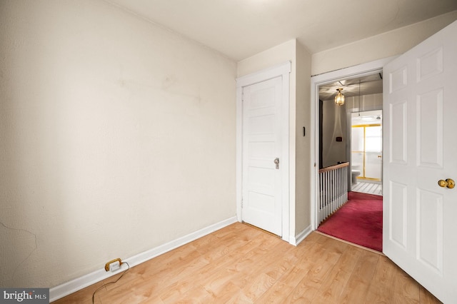 unfurnished bedroom with light wood-style flooring and baseboards