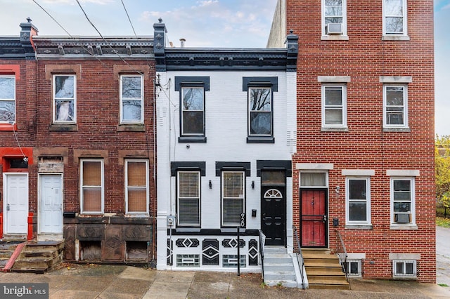 multi unit property featuring entry steps and brick siding