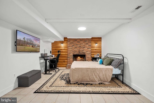 bedroom with baseboards, visible vents, log walls, a fireplace, and beamed ceiling