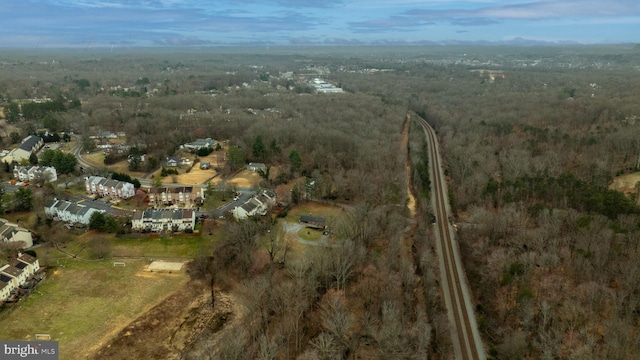 bird's eye view with a wooded view