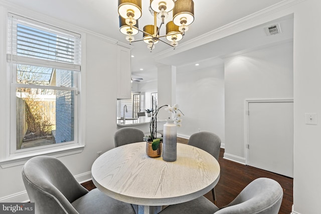 dining space with an inviting chandelier, a healthy amount of sunlight, visible vents, and dark wood-style flooring