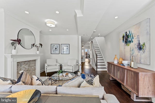 living area with stairs, crown molding, recessed lighting, and wood finished floors