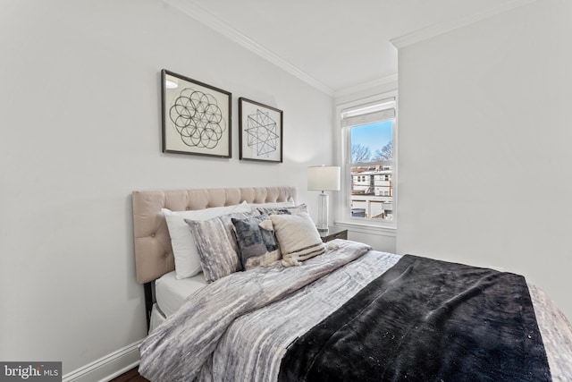 bedroom featuring crown molding and baseboards