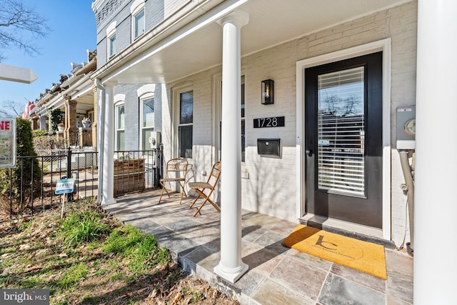 view of exterior entry with covered porch