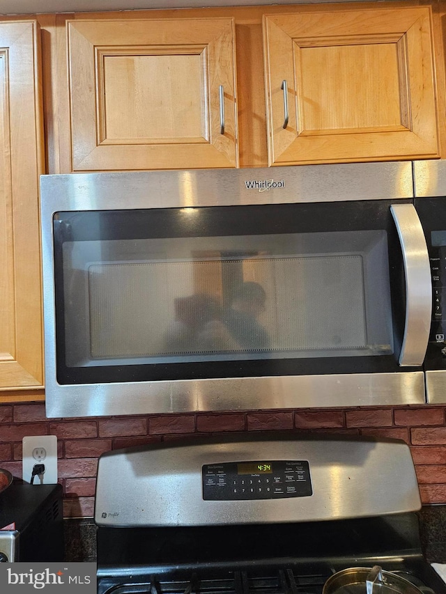 interior details with stove, stainless steel microwave, and wall oven