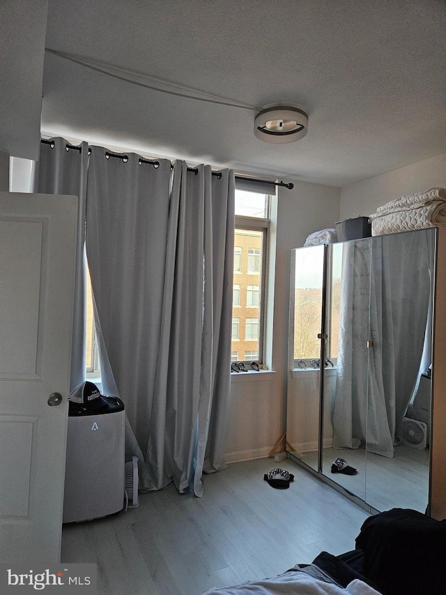 unfurnished bedroom featuring a textured ceiling and wood finished floors