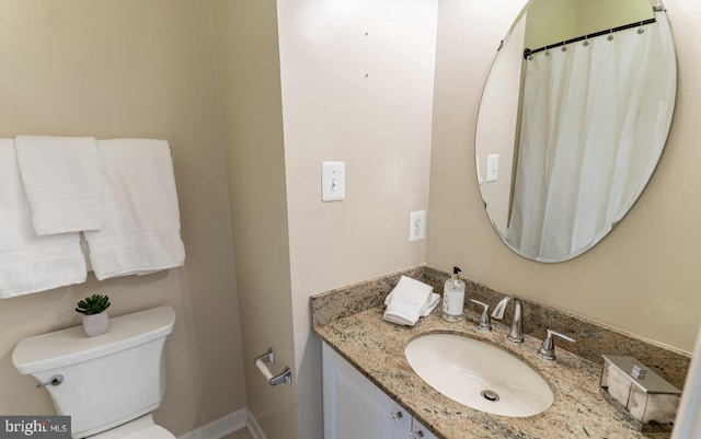 bathroom with toilet and vanity