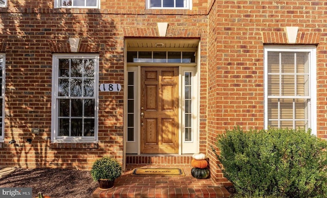 property entrance featuring brick siding