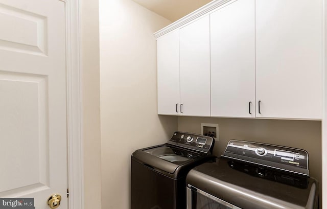 laundry area featuring cabinet space and washing machine and clothes dryer