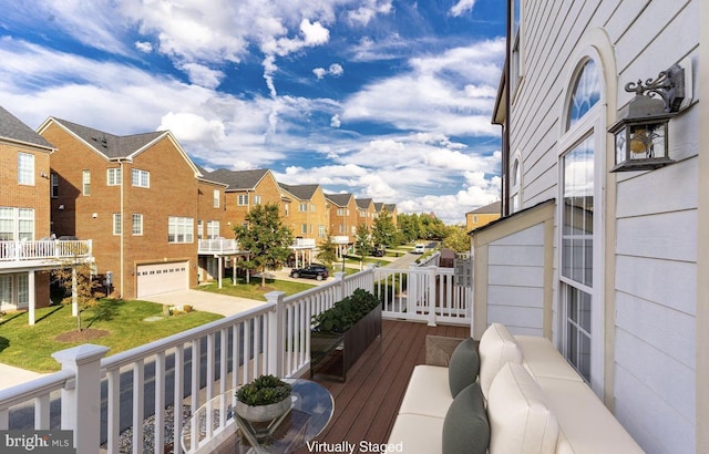 deck with a residential view and an attached garage