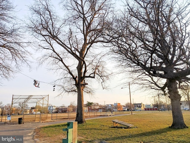 view of community with a yard and fence