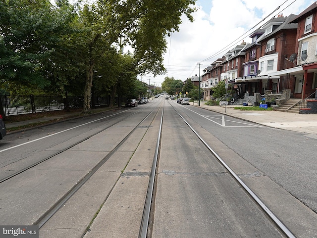 view of street featuring sidewalks, a residential view, and curbs