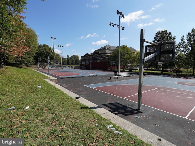 view of basketball court with a lawn and community basketball court