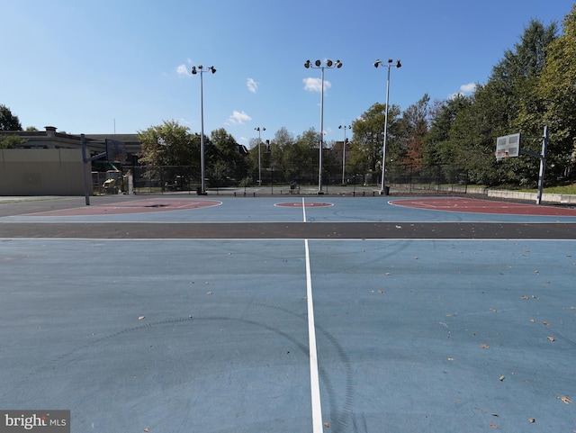 view of basketball court featuring community basketball court and fence