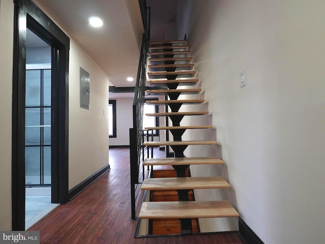 stairway featuring recessed lighting, baseboards, and wood finished floors