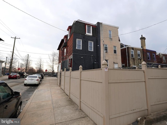 view of side of home featuring fence