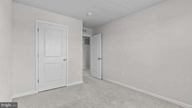 unfurnished bedroom with visible vents, carpet floors, and baseboards