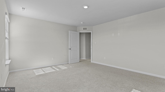 unfurnished bedroom with visible vents, baseboards, and carpet