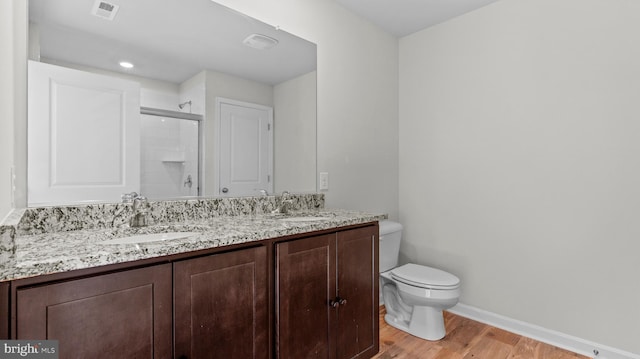 full bath featuring visible vents, a stall shower, toilet, and a sink