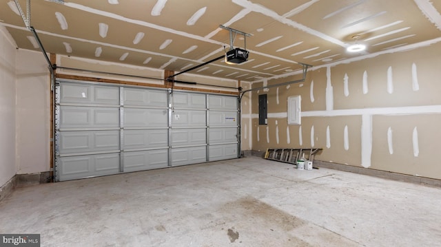 garage featuring electric panel and a garage door opener