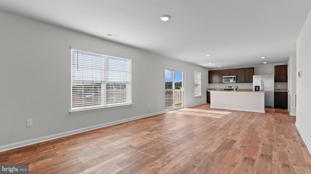 unfurnished living room featuring recessed lighting, visible vents, baseboards, and light wood-style floors